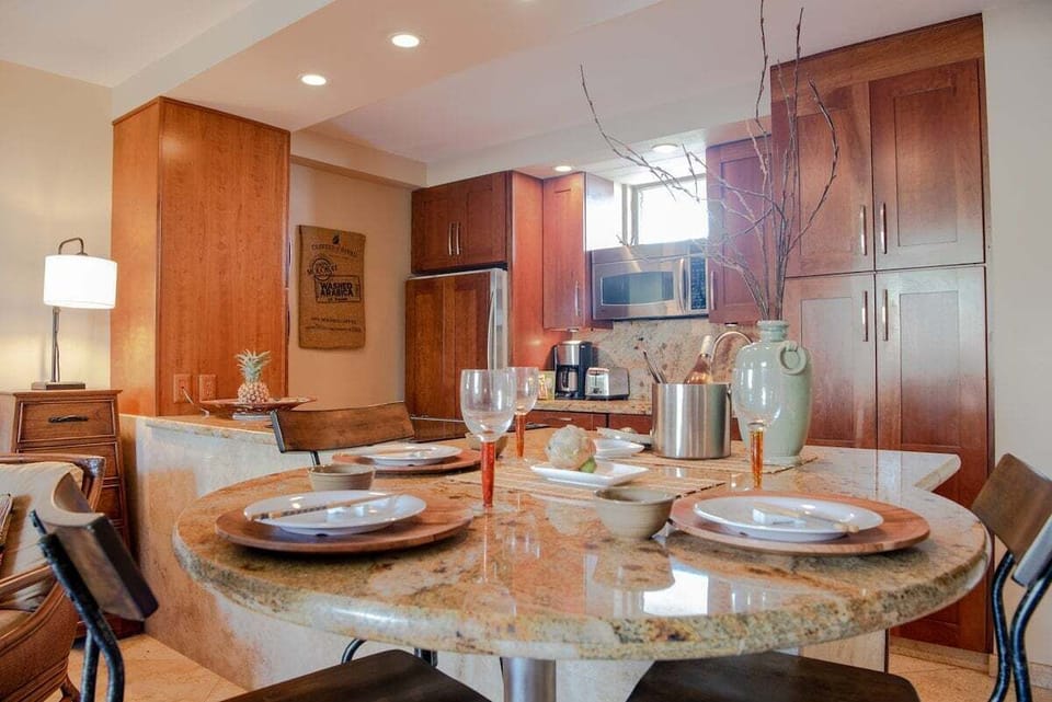 A cozy dining nook beside the kitchen provides an inviting spot for casual meals surrounded by natural light.