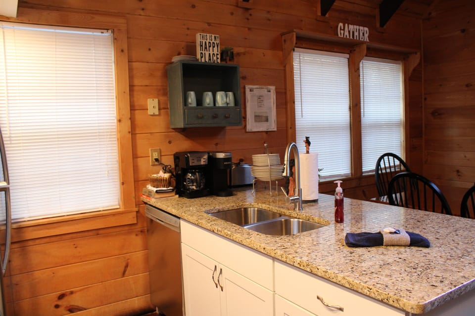 The kitchen peninsula, with breakfast station and dishware.