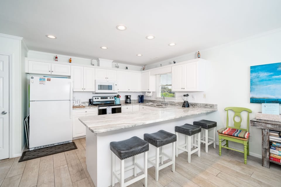 Well equipped kitchen with additional stool seating