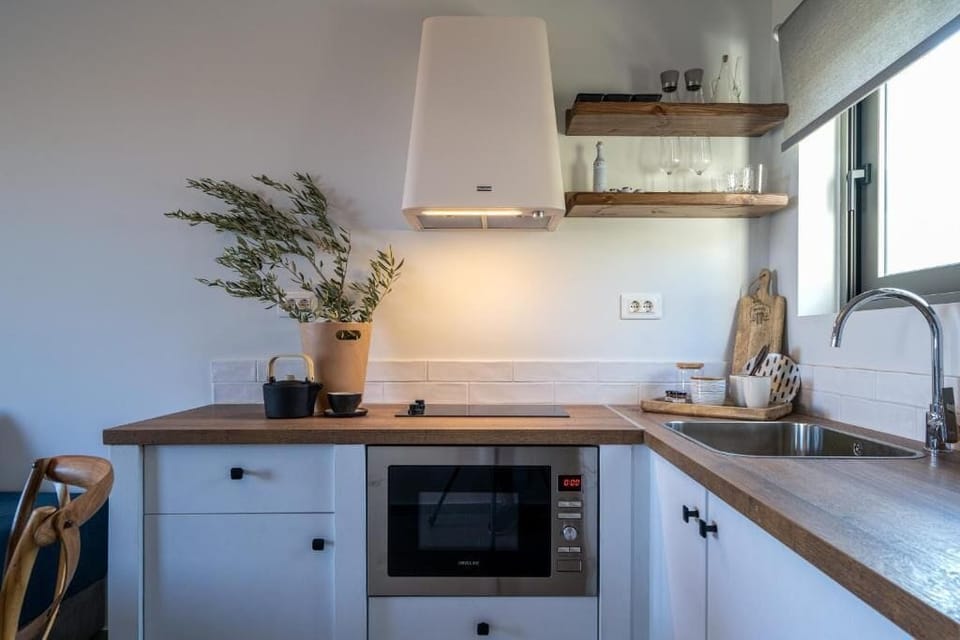Mini-fridge, stovetop, electric kettle, cookware/dishes/utensils