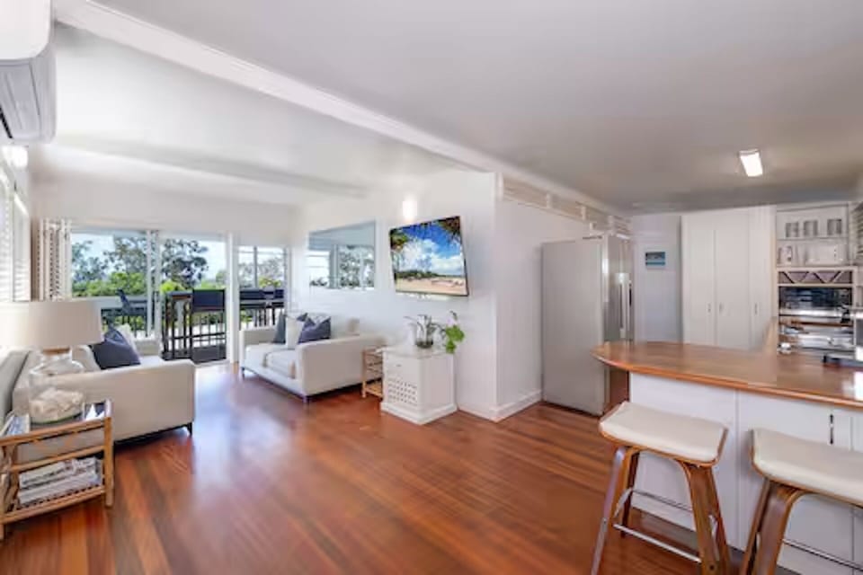 Air-conditioned living room with 60” smart TV.