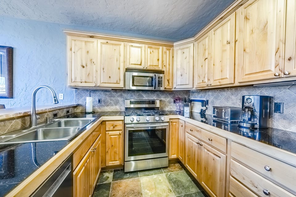 Kitchen - Galley style kitchen with stainless steel appliances