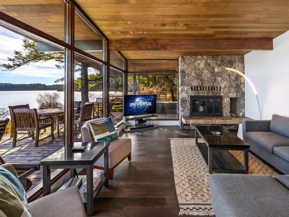 Living room with water views - Enjoy use of the electric fireplace.