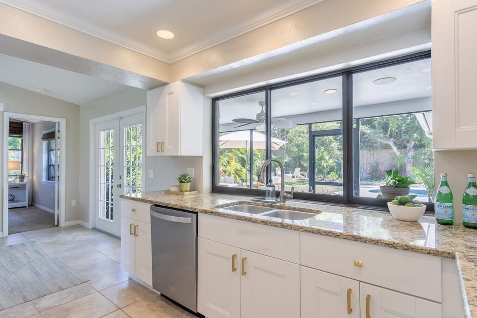 Kitchen with operable window pass through to outdoor dining area
