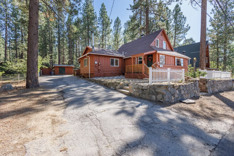 Charming two-story home with a welcoming front entrance and long driveway 

