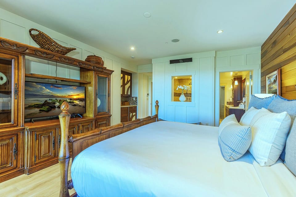 Sink into crisp linens and coastal serenity in this tranquil bedroom suite. Soft blue tones and warm wood accents create your perfect beachside retreat, with an ensuite ready to refresh you.