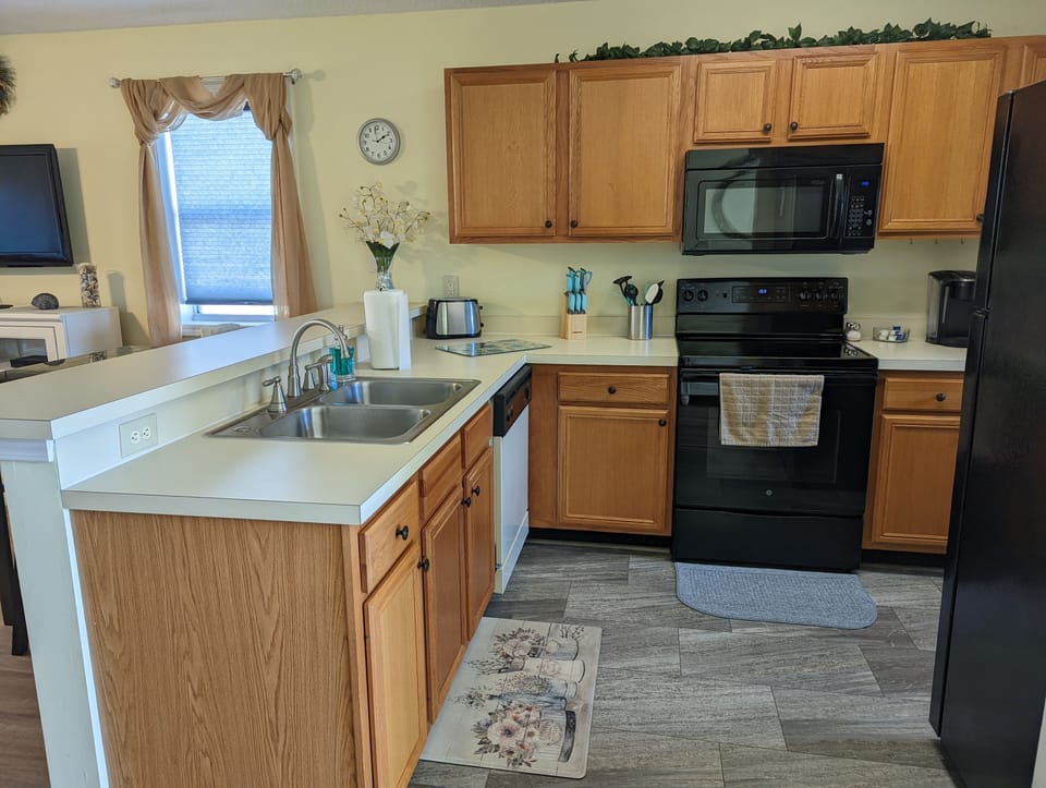 Kitchen / stocked with pots/pans, utensils, cups, plates, coffee maker, toaster