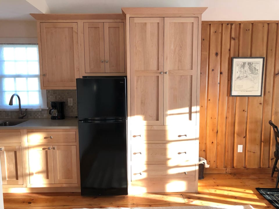Kitchen sink, cabinets, refridgerator and tall cabinet for clothing storage