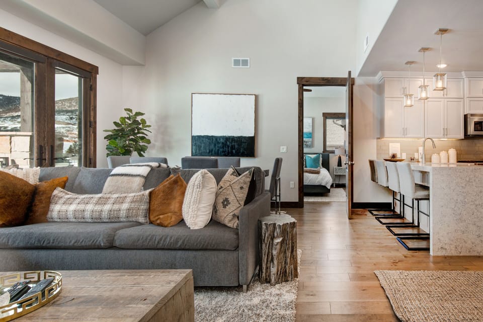 Professionally decorated Living Room with 55" Samsung smart tv, gas fireplace, large sectional sofa with sleeper, and breathtaking views of the Canyons Golf Course and Resort
