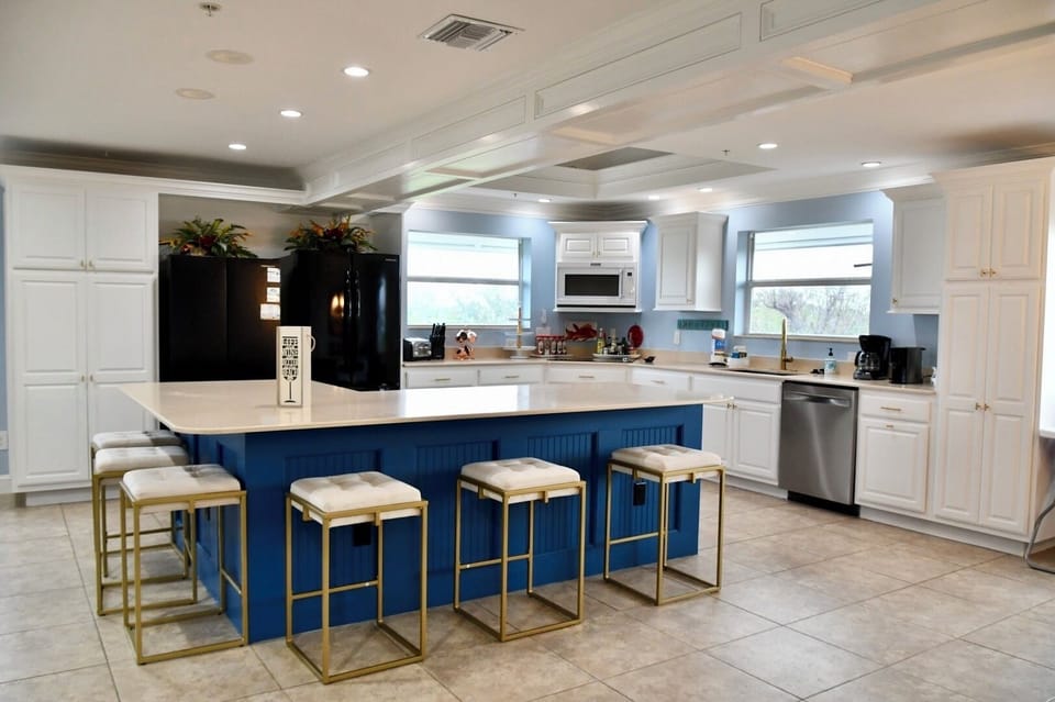 Spacious kitchen with oversized island, fully equipped for all your cooking needs.