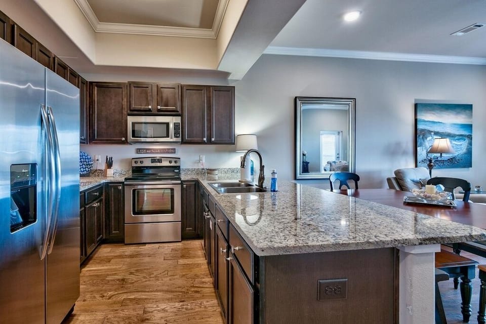 Kitchen with full size refrigerator, stove, microwave and dishwasher. 
