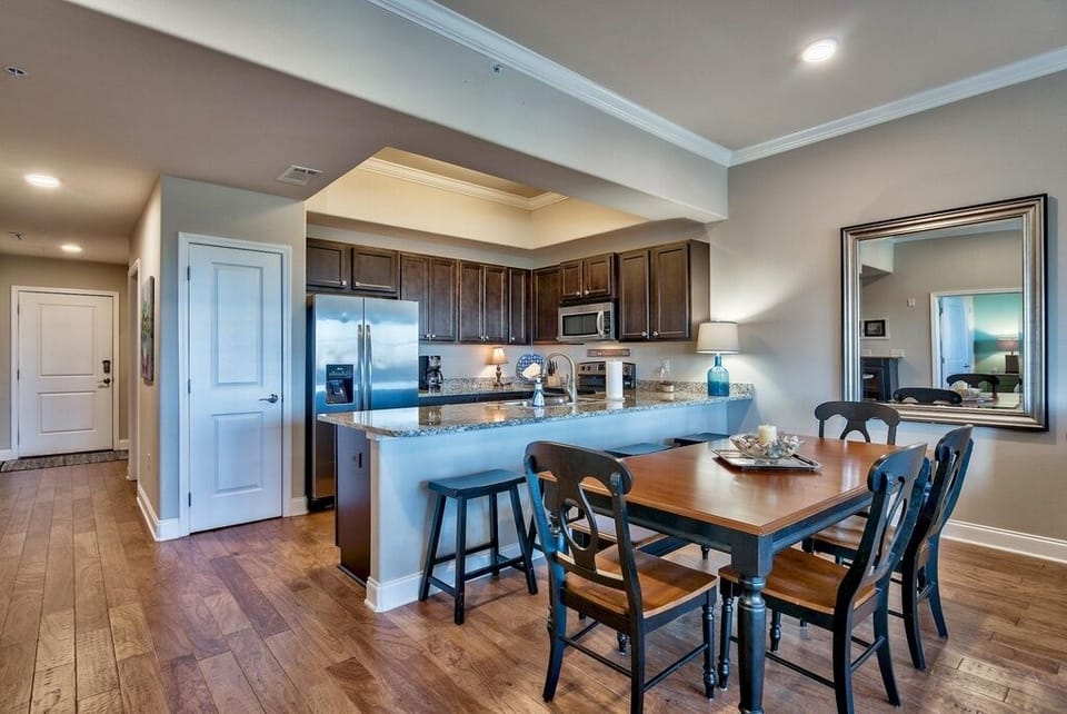 Dining area with dining table with seating for 7, plus 4 stools at counter.