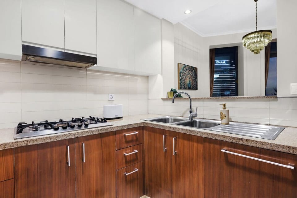 Kitchen: Sleek appliances and elegant decor make meal prep a delight in this chic space!