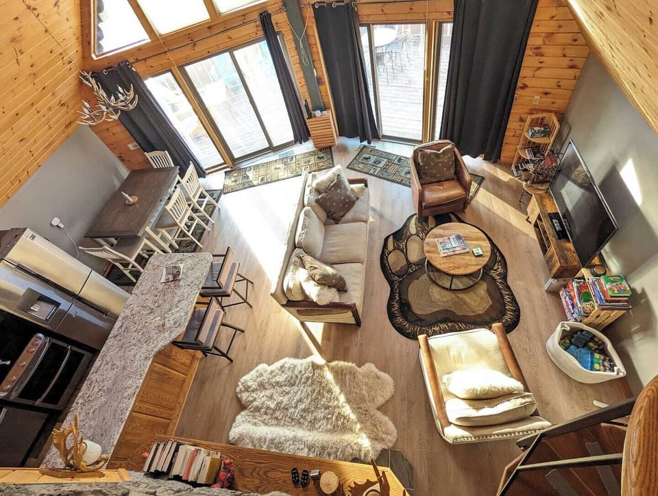 View from the top of the spiral stairs: Living room and kitchen. All levels now have LVP flooring instead of carpet.  
