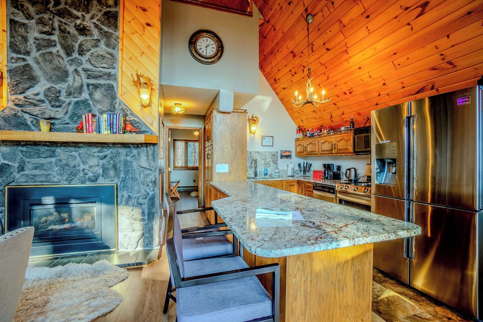Open kitchen with breakfast bar overlooking the living space.