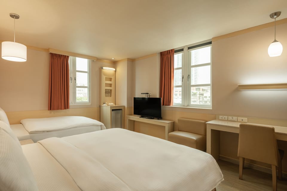 Deluxe Triple Room | Living area | 32-inch LCD TV with cable channels, TV