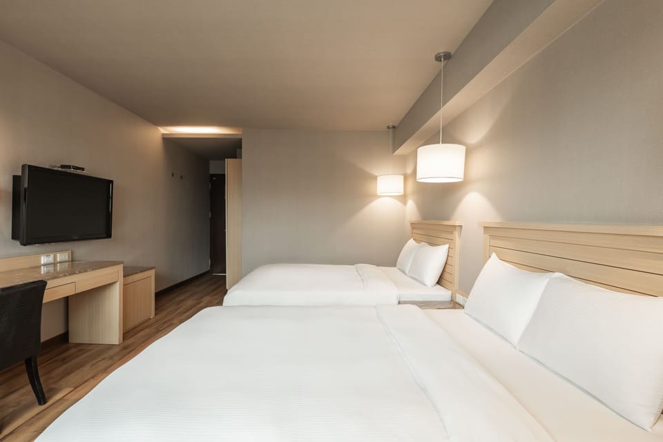 Deluxe Room, 2 Double Beds | Living area | 42-inch LED TV with cable channels, TV