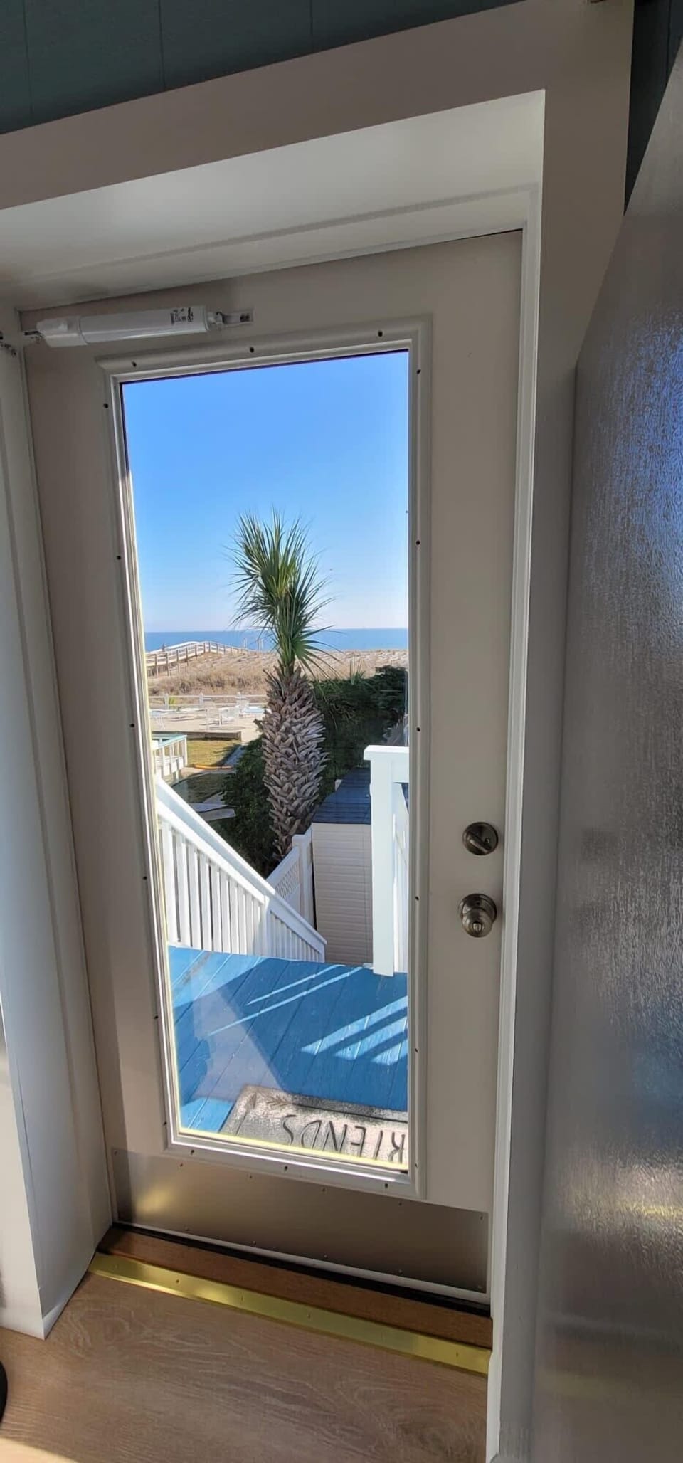 View from upstairs kitchen door leading to balcony.