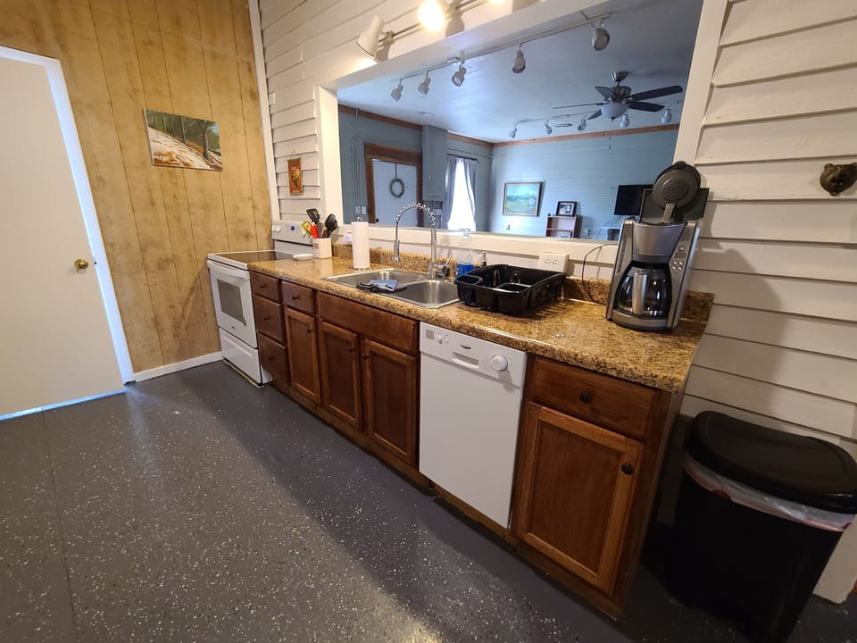 Kitchen area, with pass-through into living room (breakfast bar on other side)