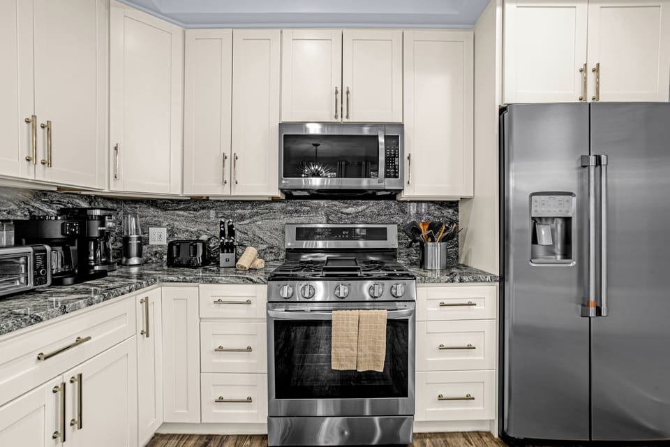 Kitchen has many appliances, including a Keurig and standard coffee pot.  