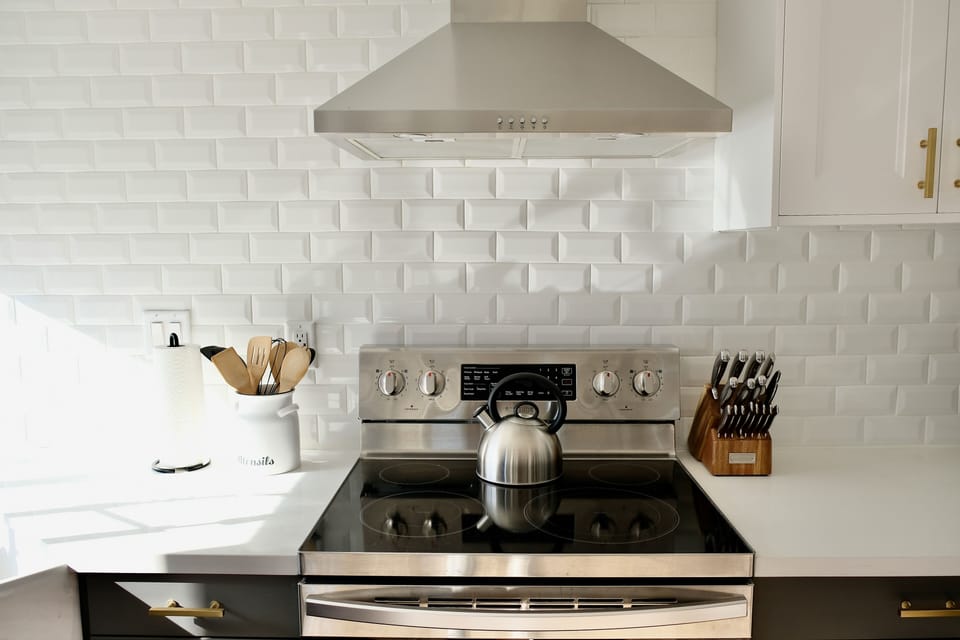 Gorgeous tiled backsplash in remodeled kitchen