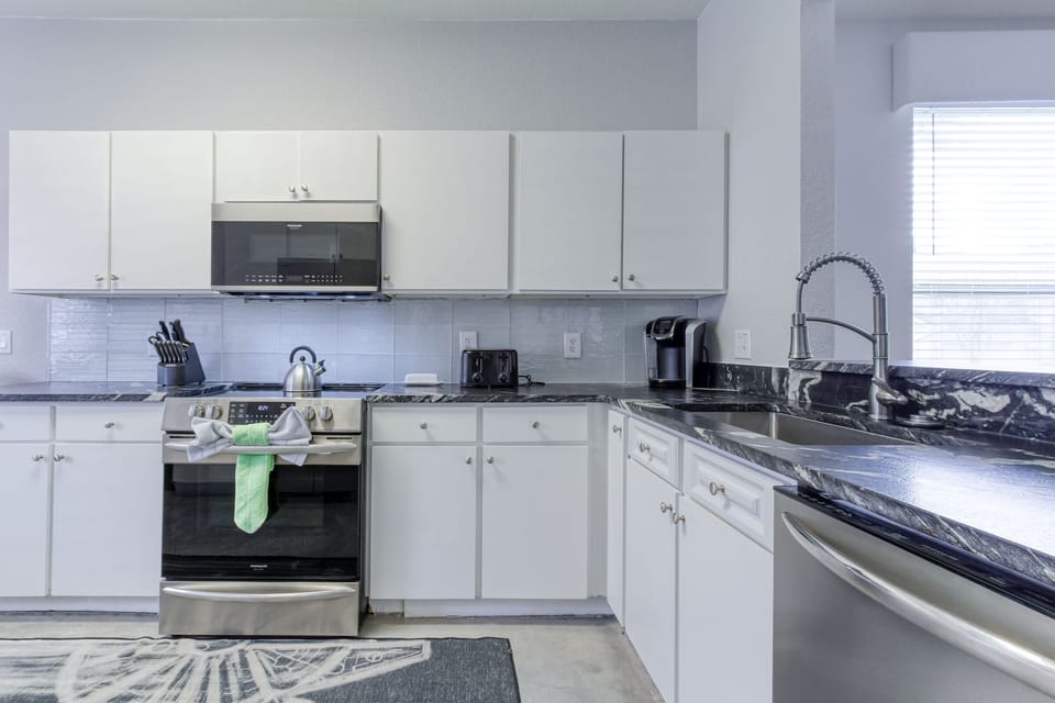 The fully equipped kitchen has a coffee station with Keurig.