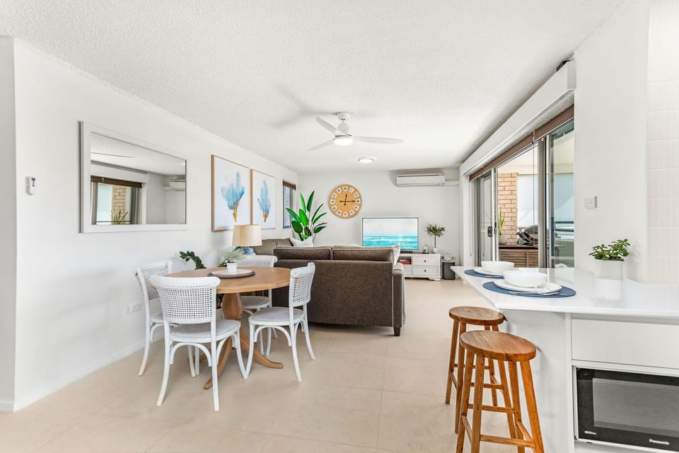 A bright and airy living space opens out to garden and beach views