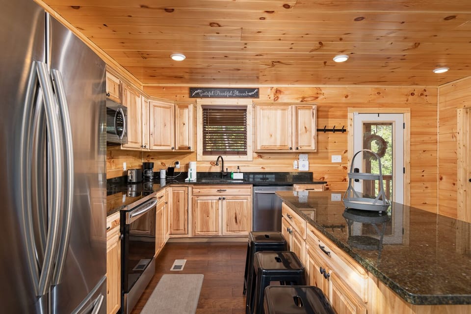 Fully stocked kitchen with large island seating—perfect for family meals.