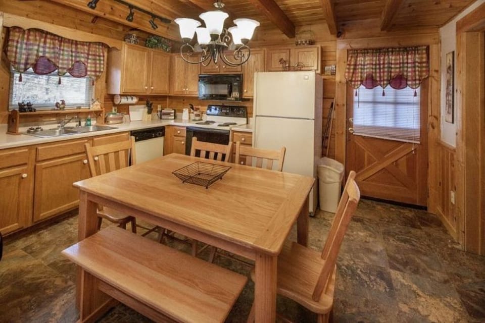 Kitchen fully stocked with cookware, utensils, dishes, etc. Dining table for 6.