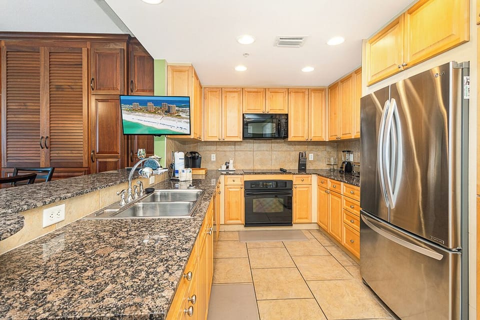 Your spacious kitchen features granite countertops, stainless steel appliances, and everything you need to create memorable meals during your stay.