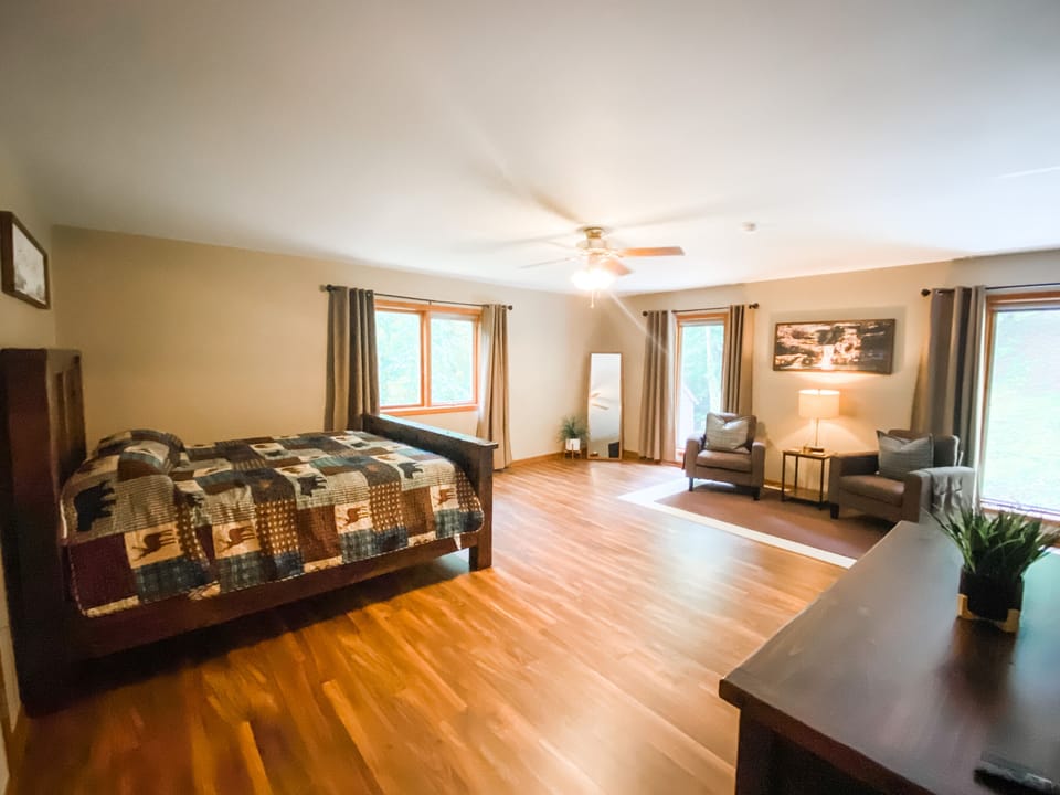 Bedroom 1 with King bed, smart tv, private sitting area and private bathroom