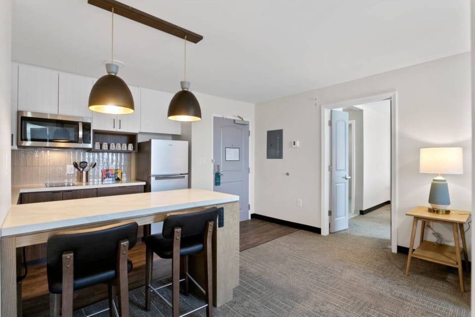 Premium bedding, desk, laptop workspace, blackout drapes