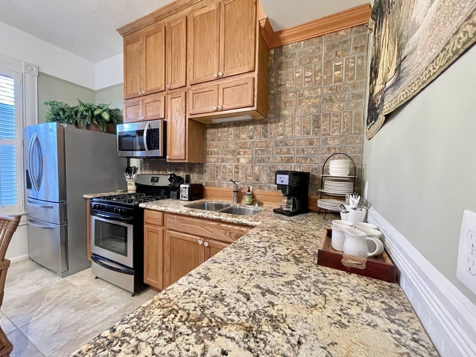 Kitchen counter, mugs, plates drip coffee maker 