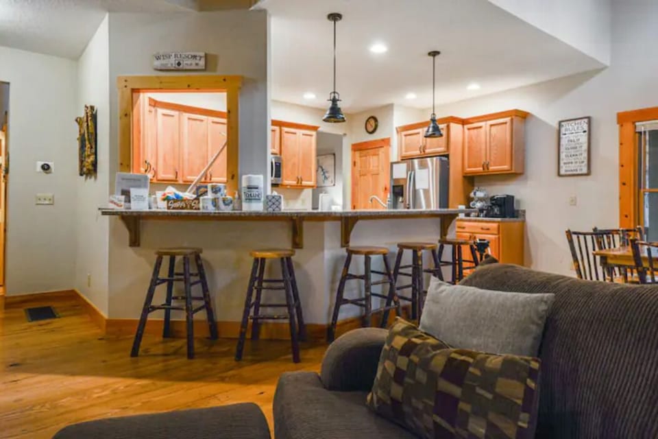 Kitchen bar with 5 barstools plus seating for 6 at the table.
