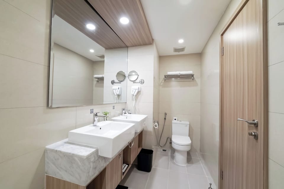 Deluxe Triple | Bathroom | Hair dryer, slippers, towels