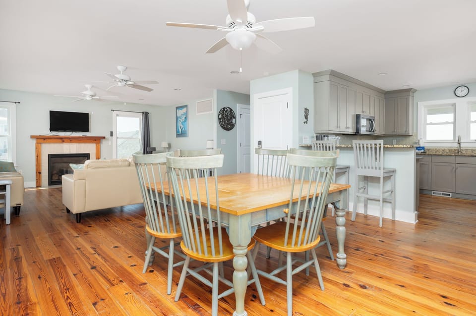 Gather around your spacious dining table while the kitchen island invites casual conversations and the cozy fireplace creates warmth.