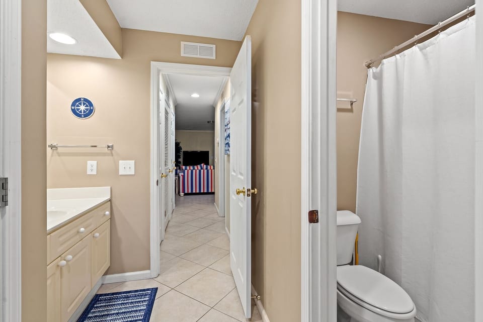 Bathroom with a shower, vanity and nautical accents at Shorehaven J1 in Tilghman Beach, North Myrtle Beach