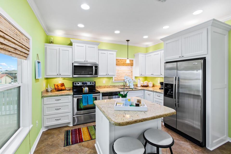 Kitchen with stainless appliances and island seating for 2.