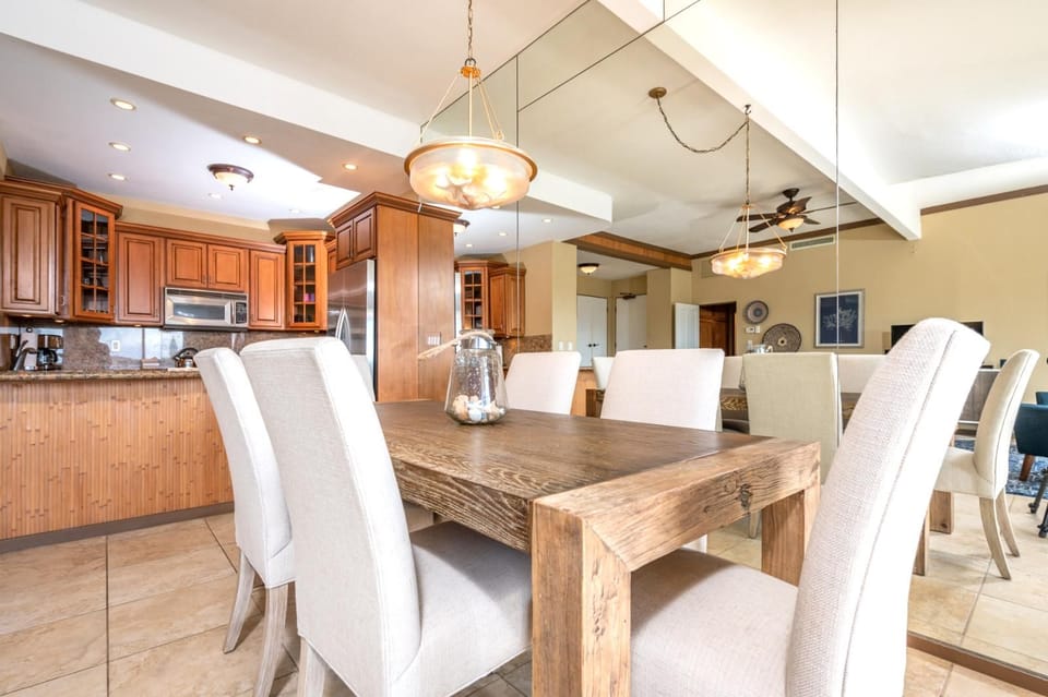 Gather around this rustic-chic dining table with plush seating, perfect for family meals, game nights, or casual island brunches    