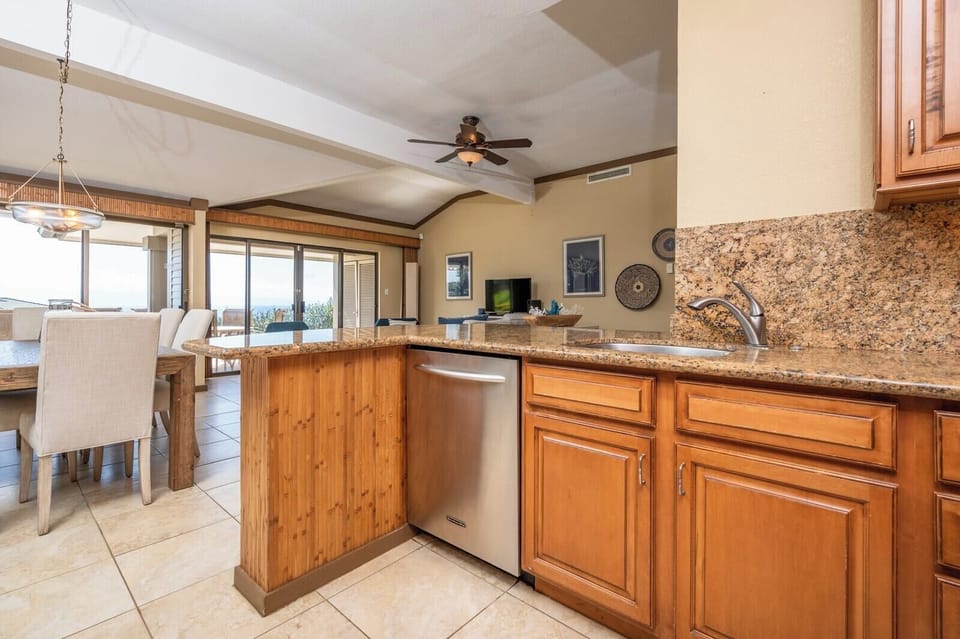 Cook, connect, and unwind in this beautifully appointed kitchen where timeless wood cabinets meet modern convenience    