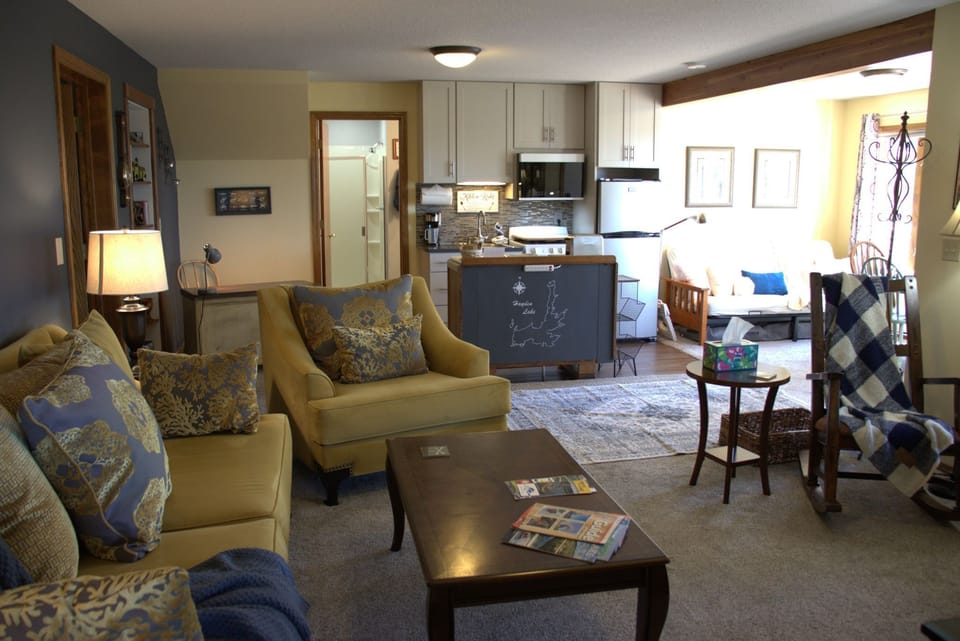 Open-concept living with kitchenette, dining & flexible sleeping space.