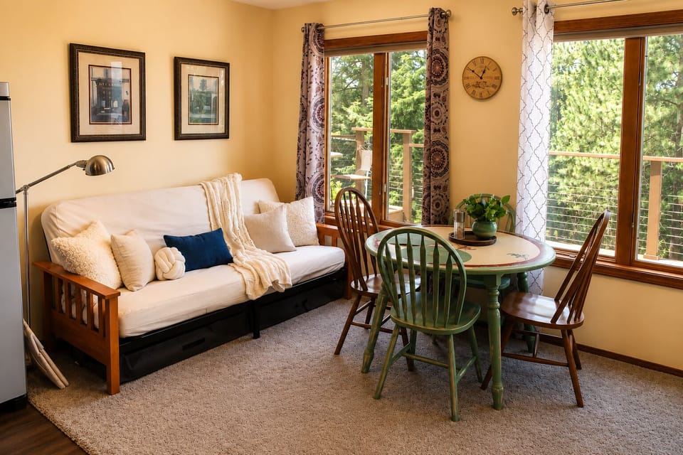 Bright dining nook with deck access and flexible sleeping space.