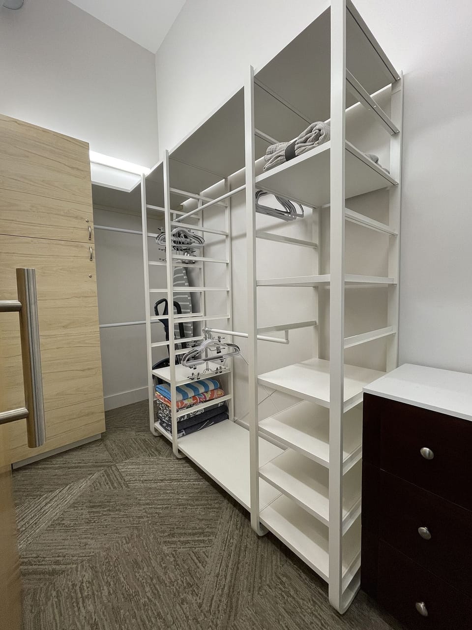 Master Closet with plenty of hanging, shelves and a dresser.