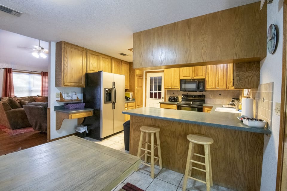 The kitchen is fully stocked with sugar, flour, oil , and spices.
