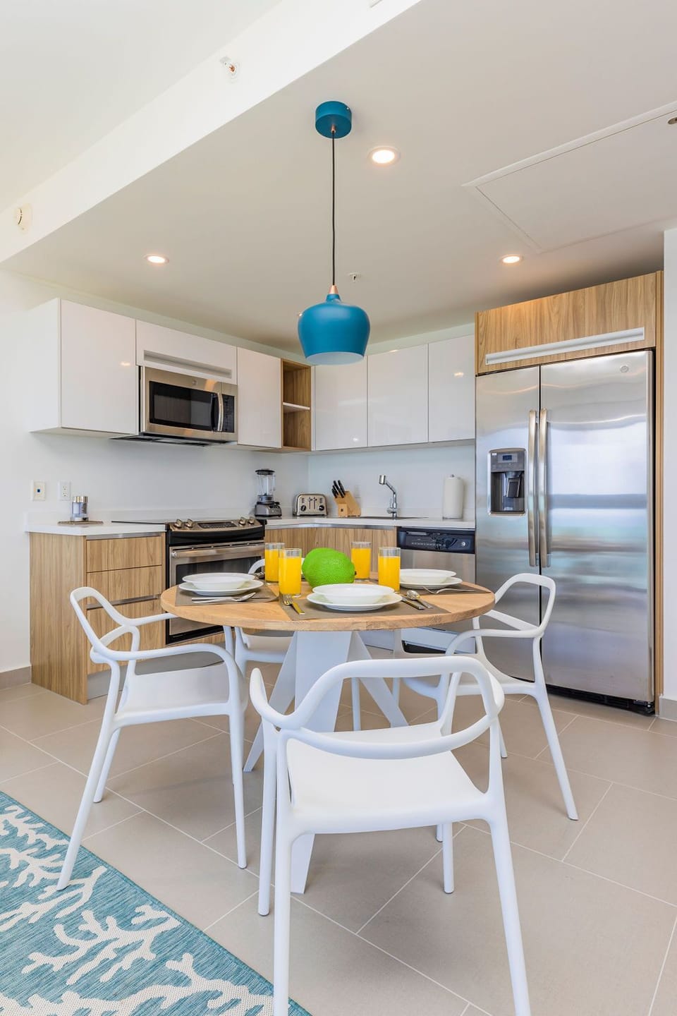 Your bright, modern kitchen and dining space invites easy meal prep with sleek appliances and a cozy table set for four—perfect for morning coffee or evening dinners together.