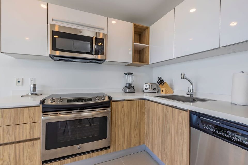 Your modern kitchen has everything you need to whip up meals, from a gas range and microwave to a blender and full sink. Clean lines and ample storage make cooking feel easy.