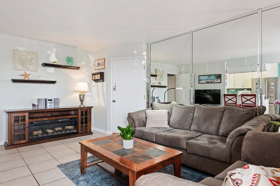 Expensive living room, facing kitchen and dining area, and patio.