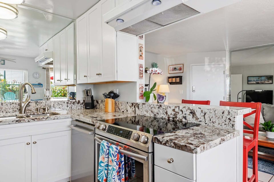 Kitchen facing living room with serving area for guests.