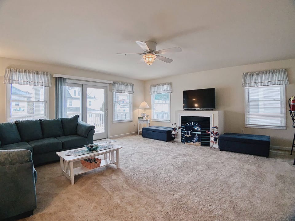 living area with fire place and two sleeper ottoman - living area with fire place and two sleeper ottoman opens to balcony/deck