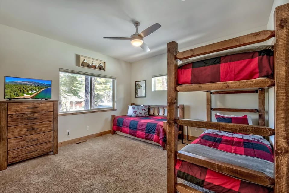 Bedroom 3 on the ground floor has 1 twin daybed with a twin trundle and a twin-over-twin bunk bed. A 32" Samsung Smart TV is perfect for movie nights before bed.